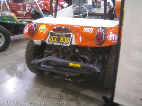 1990 Ford Bronco - tail of an orange Meyers Manx dune buggy shows round taillights, a yellow plate reading VCL 838 and a swept tubular exhaust over the rear e…