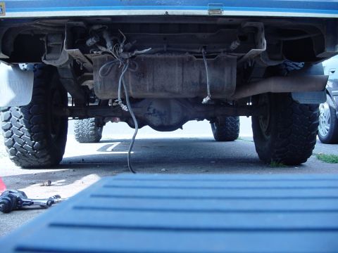 1985 Ford Bronco - Underside view of a 1985 Ford Bronco, showing the rear axle and fuel tank assembly.