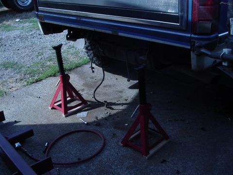 1985 Ford Bronco - Vehicle frame elevated on jack stands, ready for maintenance or repair work.