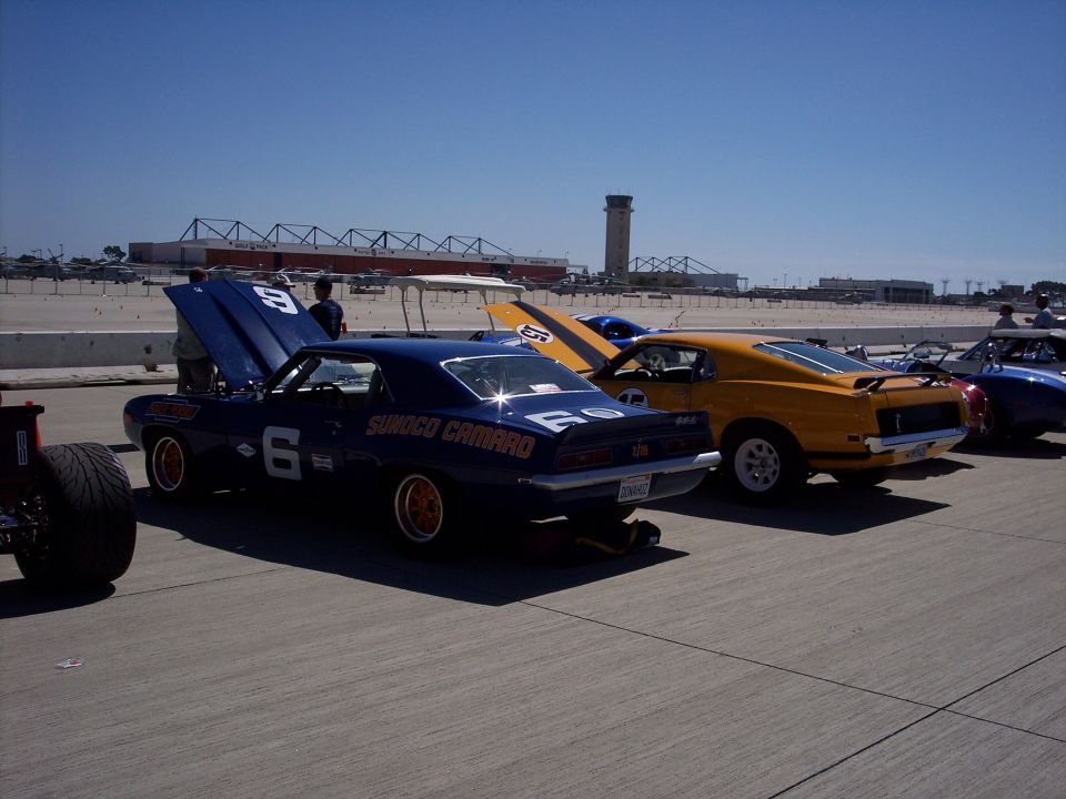 Blue 1969 Camaro race car with "Sunoco Camaro" text and number 6, parked on asphalt