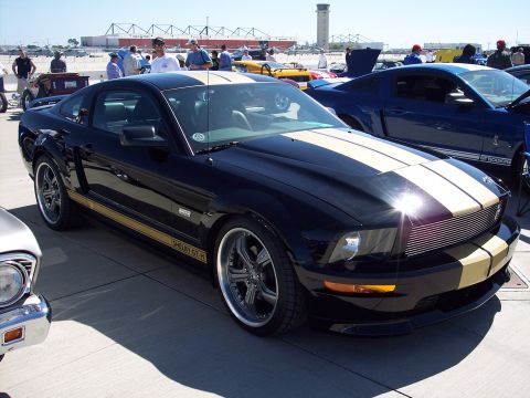 1971 Ford Mustang - A black 2007 Shelby GT-H Mustang is parked at an outdoor car show with other vehicles.