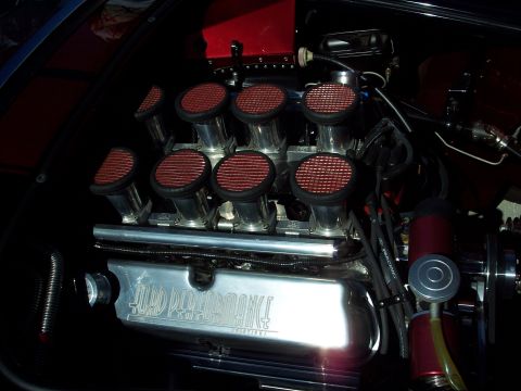 1971 Ford Mustang - Close-up of a Ford Performance engine eight individual throttle bodies and chrome valve covers.
