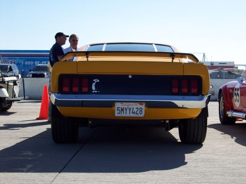 1971 Ford Mustang - Rear view of a yellow 1971 Ford Mustang, a black stripe and California license plate.