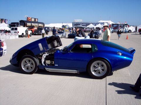 1971 Ford Mustang - A blue Shelby Cobra Daytona Coupe replica is displayed with its hood open, revealing the engine compartment.