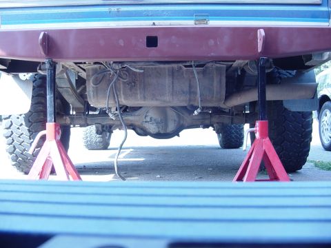 1985 Ford Bronco - Underneath view of a 1985 Ford Bronco, with the rear axle and fuel tank visible.