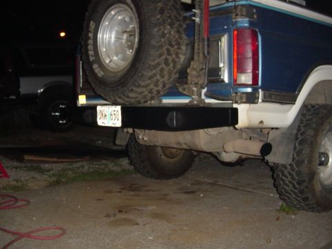 1985 Ford Bronco - Rear view of a 1985 Ford Bronco showing the bumper and spare tire. License plate is visible.