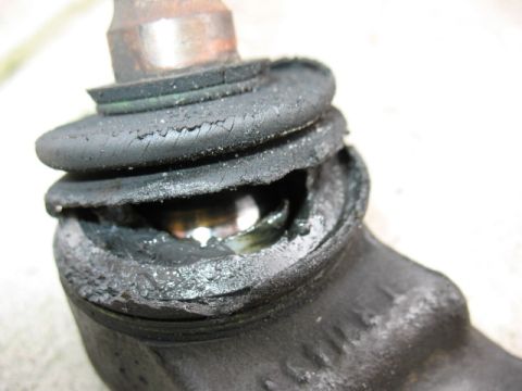 1997 Ford Crown Victoria - The rubber boot on this ball joint is severely damaged, exposing the internal components and grease.