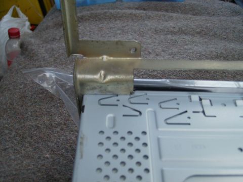 1979 Ford F-100 - A metal bracket, likely for a car radio, shows signs of damage and wear.