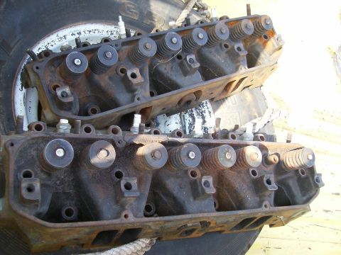 1979 Ford F-100 - Engine cylinder heads, likely from a V8 engine, are shown in a close-up view with visible rust and wear.