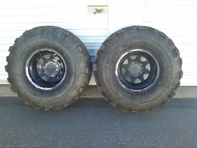 Two large off-road tires on black rims