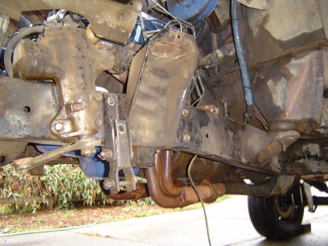 1978 Ford Bronco - Close-up view of the front suspension and steering assembly, showing the exhaust manifold and frame structure.