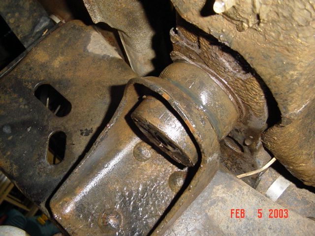 Rusty undercarriage bracket and bushing mount on a 1985 Ford Bronco, dated Feb 5 2003
