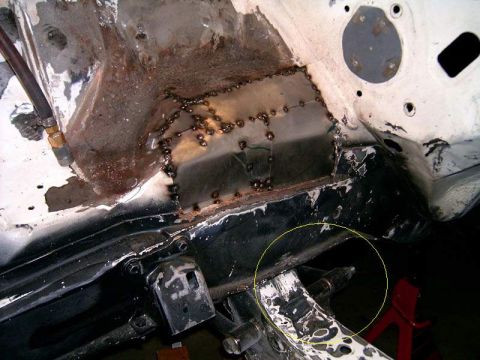 1978 Ford Mustang II - Close-up view of a welded metal patch on a car's frame, showing signs of rust and repair work.