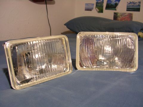 2007 Mazda 3 - A pair of aftermarket headlights are displayed on a bedspread.