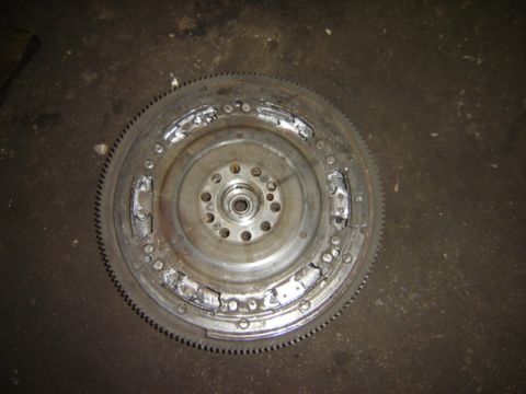 1992 Ford Bronco - Flywheel shows significant damage to the clutch engagement surface and the starter ring gear.