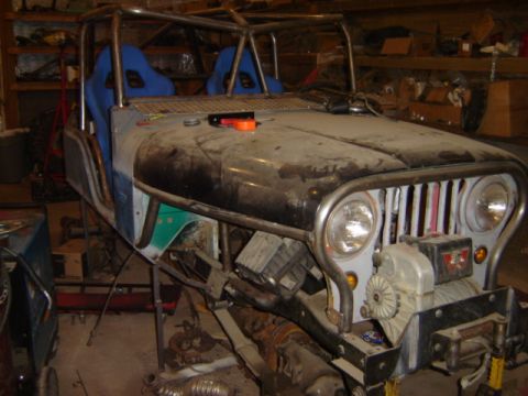 1992 Ford Bronco - Custom off-road vehicle build in progress, a roll cage and racing seats.