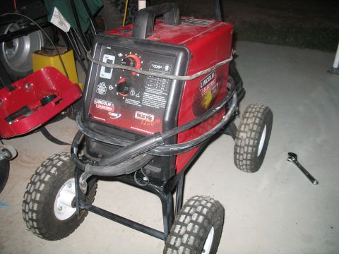 1992 Ford Bronco - A red Lincoln Electric Weld Pak 3200 welding machine is mounted on a wheeled cart.