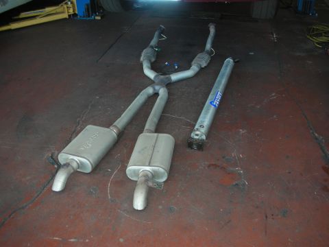 1992 Ford Crown Victoria - Vehicle transmission parts laid out on a workshop floor.
