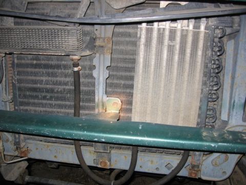 1989 Ford Bronco - Close-up of a vehicle's radiator and oil cooler assembly, showing hoses and mounting brackets.