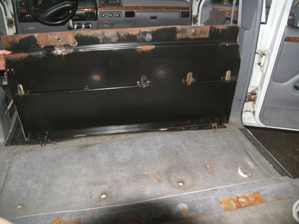 1995 Ford C-350 (Centurion Conversions) interior showing removed rear seat mounting brackets and carpet