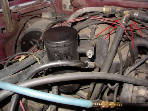 1988 Ford C-350 (Centurion Conversions) - Close-up view of engine bay components, including hoses and wiring, with red arrows indicating specific areas.