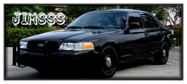 1998 Ford Crown Victoria - This black sedan features a push bar and steel wheels, resembling a police vehicle.