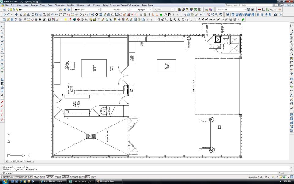AutoCAD screenshot of a dimensioned building floor plan with rooms, stairs, and workbench layout