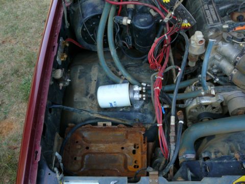 1988 Ford Bronco - Close-up of an engine bay, highlighting a fuel filter and associated components.