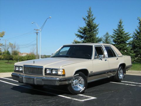1988 Mercury Grand Marquis - This 1988 Mercury Grand Marquis is shown in a parking lot under a clear blue sky.
