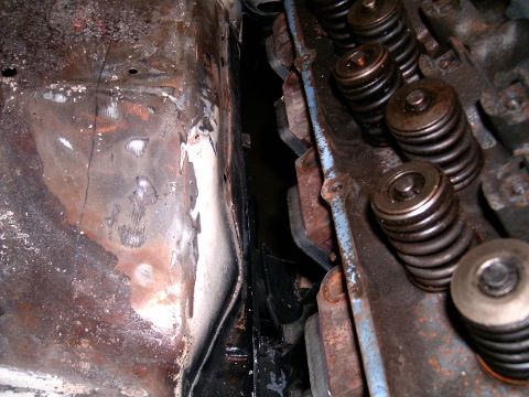 1978 Ford Mustang II - A close-up view of the valve springs and rocker arms on an engine, showing signs of wear and tear.