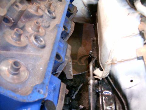 1978 Ford Mustang II - Detail of engine components, including a blue valve cover and associated parts, viewed from an engine compartment.