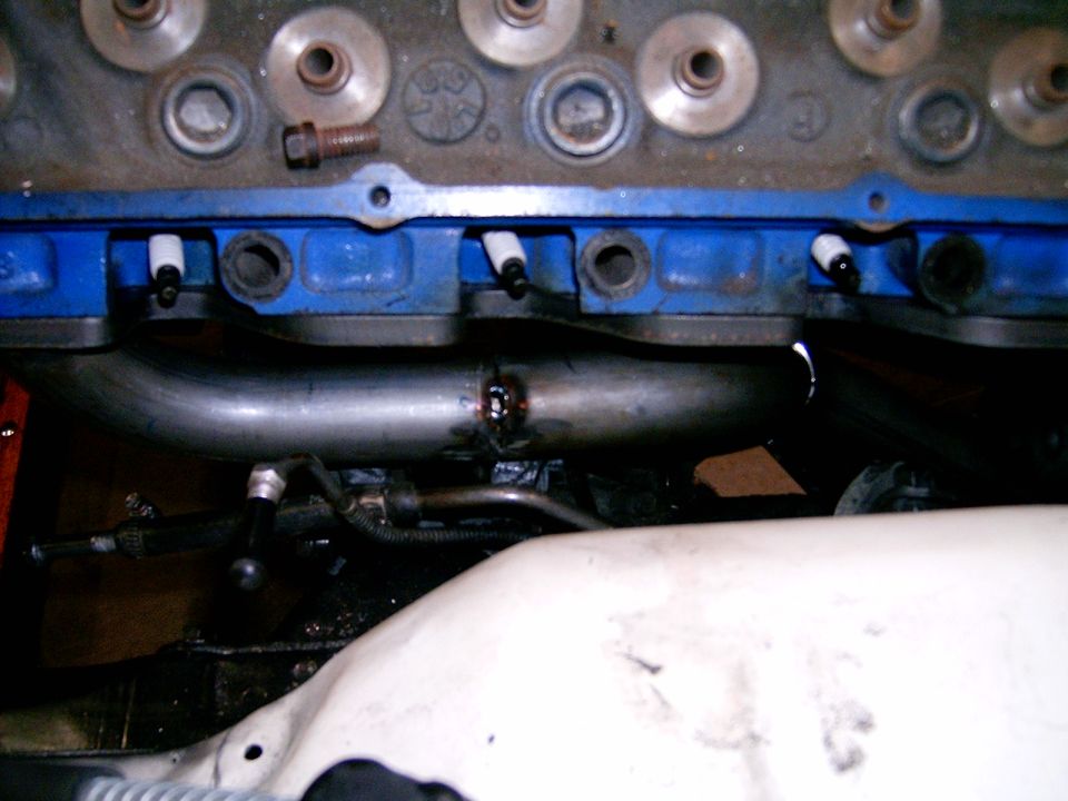 Engine exhaust headers with blue valve covers and spark plug wires