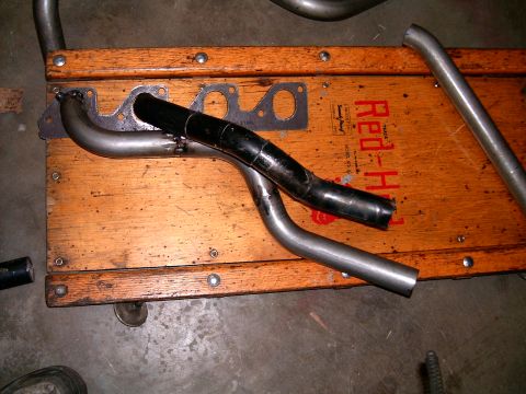 1978 Ford Mustang II - Exhaust headers and pipes are laid out on a wooden cart, ready for installation.
