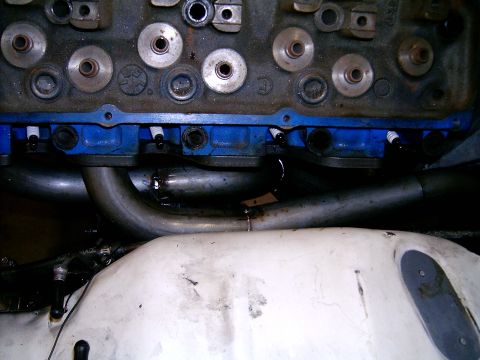 1978 Ford Mustang II - Close-up view of an engine block headers and spark plugs.