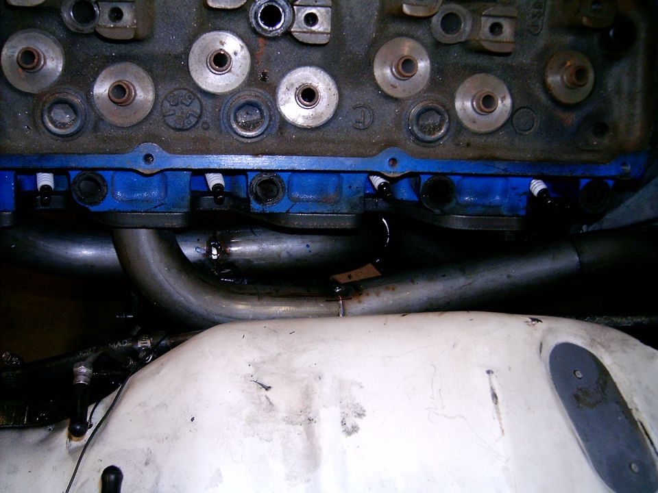 Engine block with headers and spark plugs