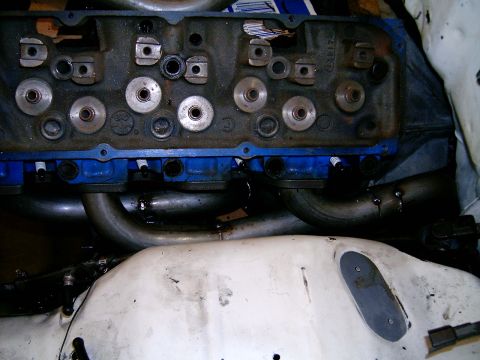 1978 Ford Mustang II - Close-up of an engine cylinder head and exhaust headers, showing internal components and spark plugs.