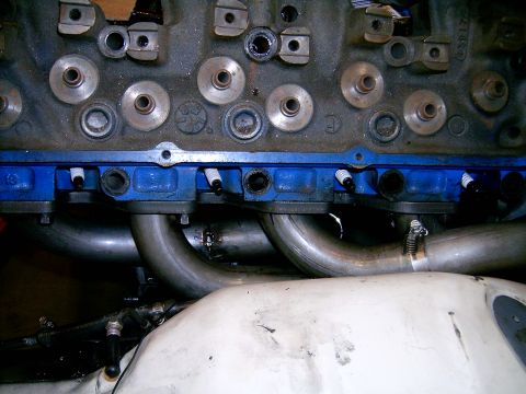 1978 Ford Mustang II - Close-up of an engine's cylinder head and exhaust headers, showing spark plugs and intake manifold.