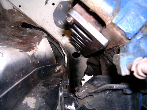 1978 Ford Mustang II - Close-up view of engine bay components, including a chrome exhaust header and rusty metalwork.