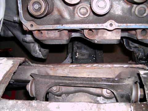 1978 Ford Mustang II - Close-up view of engine components, including the valve cover and exhaust manifold, with suspension parts visible underneath.