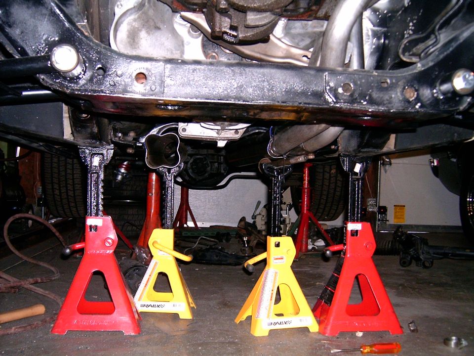 Underside of a car on jack stands, showing exhaust and frame