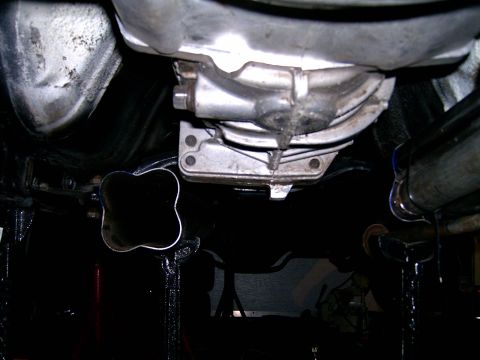 1978 Ford Mustang II - Underside view of a vehicle's transmission and exhaust system components.