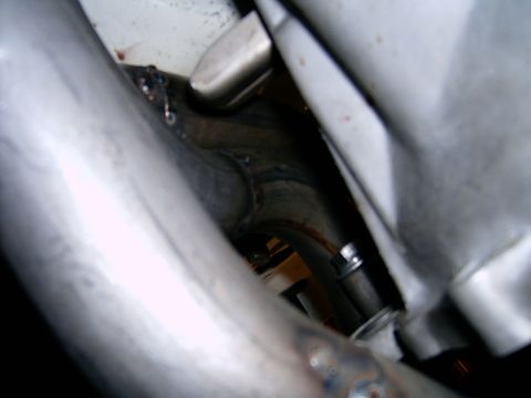 1978 Ford Mustang II - Close-up view of custom exhaust headers, showing welding details and a bolted connection.