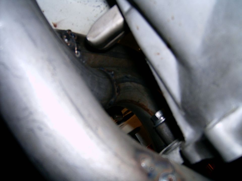 Exhaust headers with visible welds and a bolt
