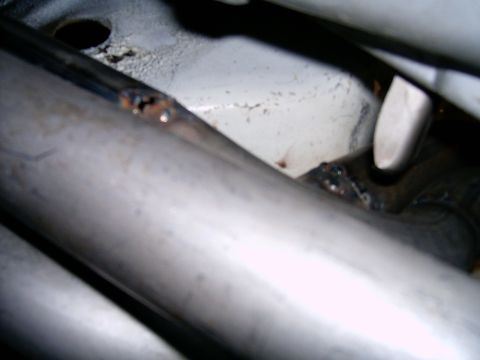 1978 Ford Mustang II - Welds on an exhaust pipe show signs of rust and wear.