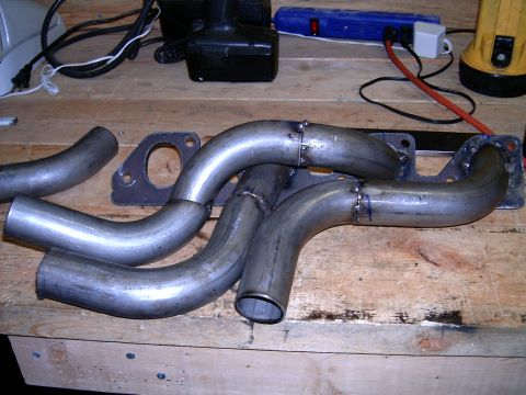 1978 Ford Mustang II - Custom exhaust headers are shown on a workbench, ready for installation.