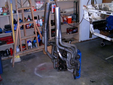 1978 Ford Mustang II - Custom exhaust headers attached to a V8 engine block in a garage setting.