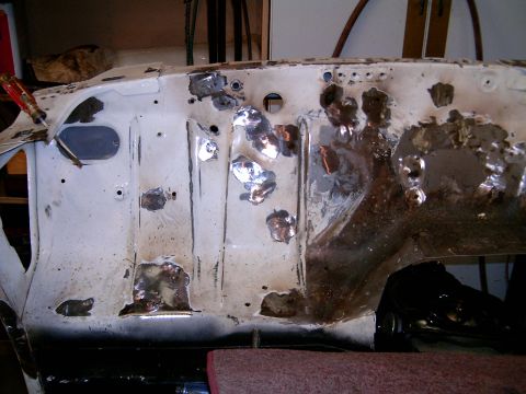 1978 Ford Mustang II - This is a close-up of a car's firewall, showing significant rust and repair work.