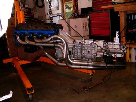 1978 Ford Mustang II - A V8 engine and transmission assembly is mounted on an engine stand, ready for installation or repair.