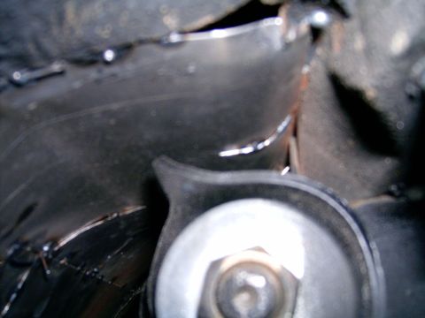 1978 Ford Mustang II - Detail of a vehicle's exhaust system, focusing on the manifold and surrounding heat shielding.