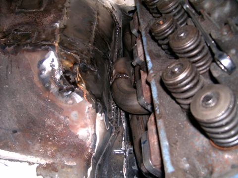 1978 Ford Mustang II - Custom exhaust pipe installation near engine valve springs, showing welded chassis modifications.